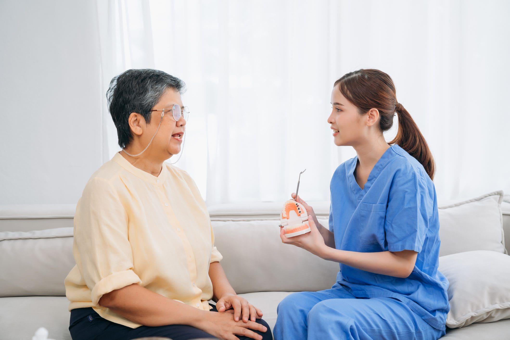 Healthcare worker discussing dental care with patient.