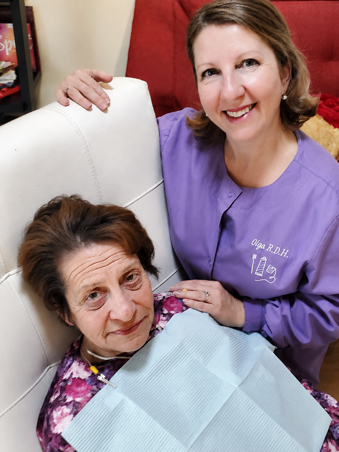 Smiling dental hygienist with elderly patient